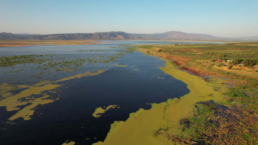 Stunning aerial footage flying over the vast Marmara Lake, showing extensive algae blooms on its surface,fa01