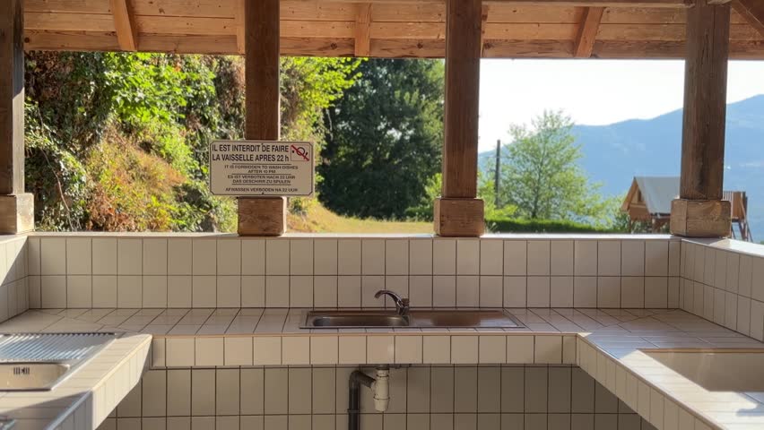Open mountain shelter with washing basin