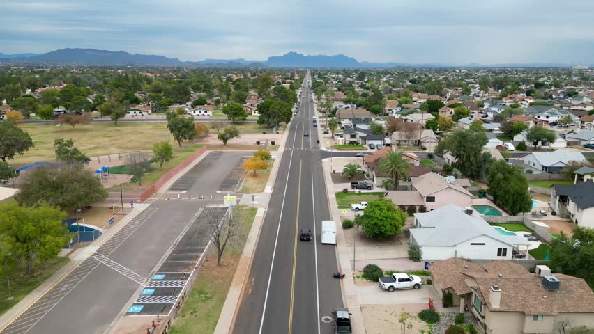 A Straight suburban road stretching through a residential neighborhood in Phoenix, Arizona, USA