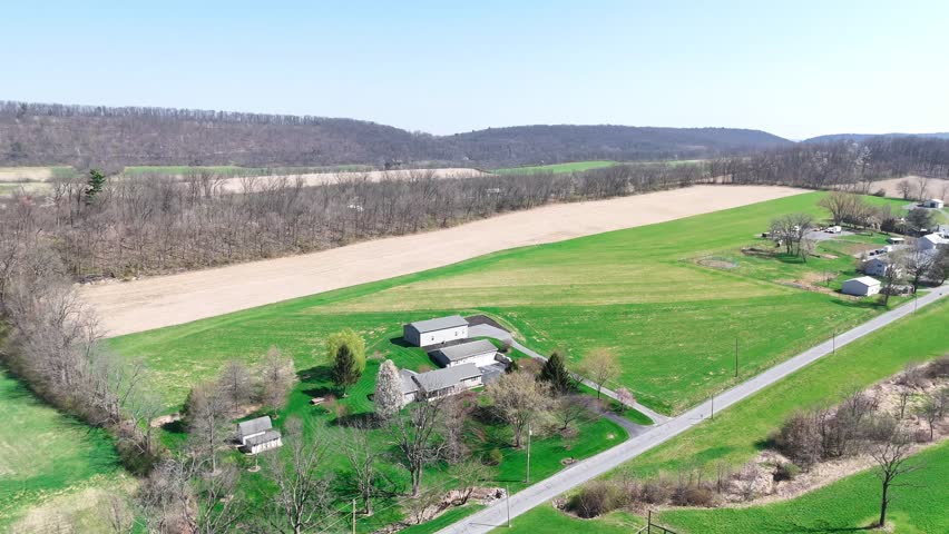 Aerial view of rural homes and fields along road near Herndon Pennsylvania