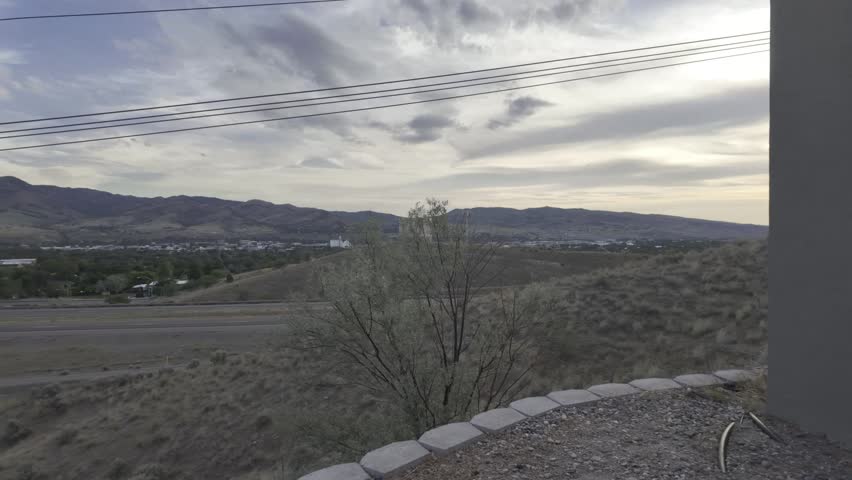 POV Outside of Pocatello Idaho Overlooking Traffic on Interstate 15 Into Pocatello Valley June 2026 Cloudy Evening