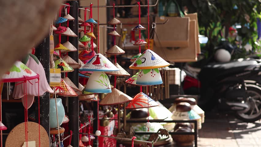 Female Tourist Looking at Handmade Vietnamese Souvenirs at Local Street Market Stall. Traditional Asian Craft Shopping and Travel Culture Close Up, Slow Motion Video.