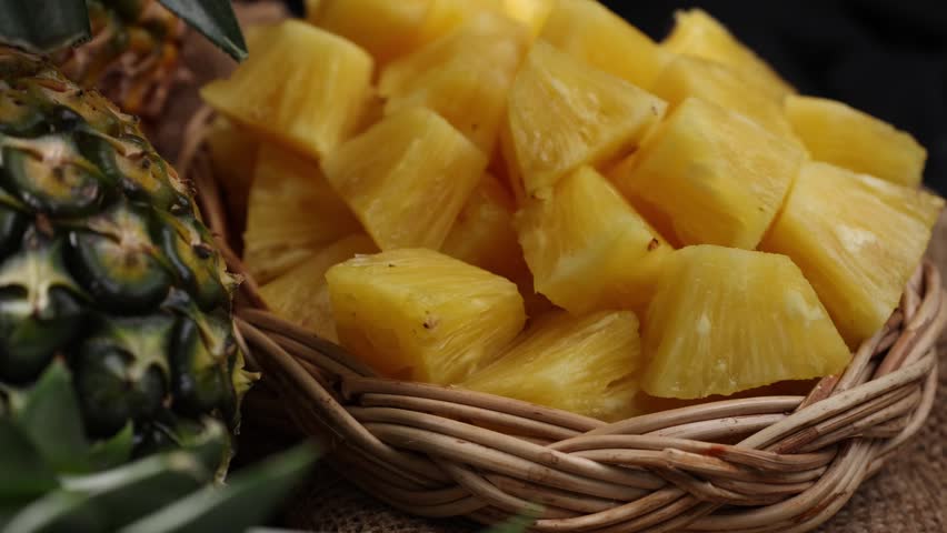 Juicy Pineapple Slices on Wooden Table with Black Background	