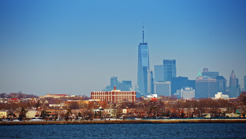 View on the Lower Manhattan, financial district of New York City. The One World Trade Center skyscraper Stands out from the skyline. Perspective from the waterscape.