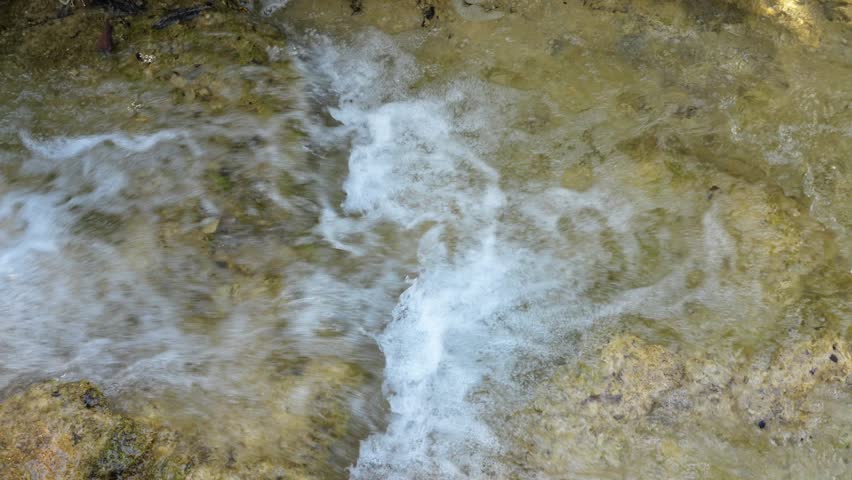 Summer Stream Flowing Down Over Travertine Calcified Rock Formations Surrounded by Lush Green Forest in Huanglong Scenic Area, Songpan, Aba, Sichuan, China