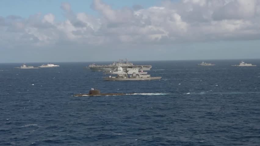 Aircraft Carrier Strike Group and Submarine Conducting Naval Operations at Sea