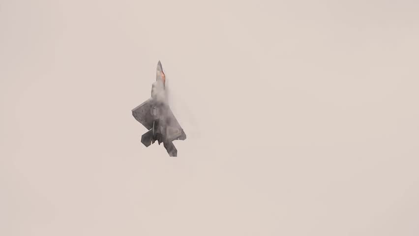 F-22 Raptor Stealth Fighter Soaring Through Sky Demonstrating Advanced Stealth Technology, Exceptional Agility, and Air Superiority Capabilities.