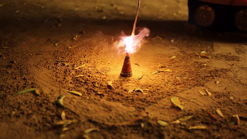 cone fountain firework emitting bright sparks during outdoor festival celebration at night