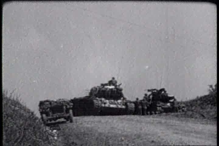 1950s - A film about the Korean War - footage of troops administering first aid to an enemy soldier and an assault on a village
