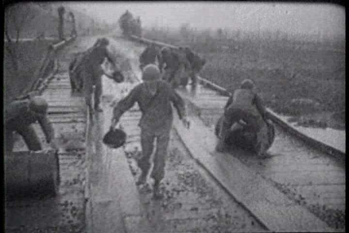 1950s - A film about the Korean War - footage of U.S. troops destroying a bridge and setting a mine field