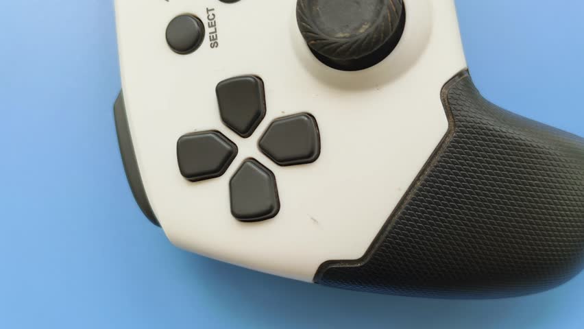 Wireless gaming console, controller, gamepad or joystick electronic device buttons rotating or spinning closeup top view. Modern e-sport global entertainment industry concept.