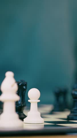 Video of close up of mature man playing chess with a friend at home