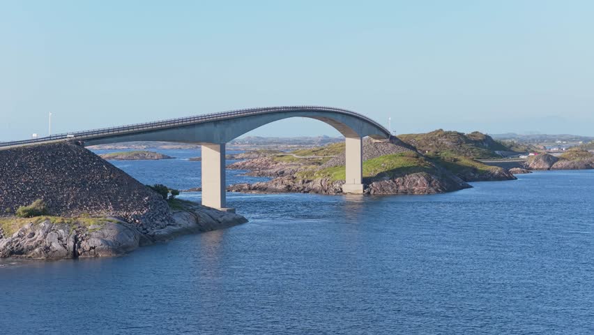 Aerial drone view of the Atlantic Ocean Road in Norway. Winding highway bridge connecting islands across rough ocean waves during a scenic coastal road trip.