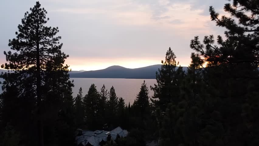 North Lake Tahoe: Drone flight through pines reveals sunset near Kings Beach and Brockway, CA