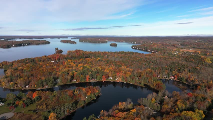 An aerial view of Lake Muskoka near Bracebridge, Ontario, Canada, showing scattered islands, shoreline cottages, and vibrant autumn forests