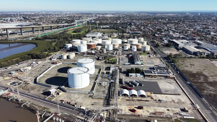 Industrial oil refinery and storage facility near a residential area and a major highway