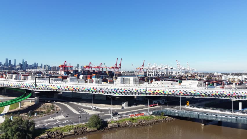 Aerial view of the port of Melbourne, with the city skyline and Footscray road in the foreground