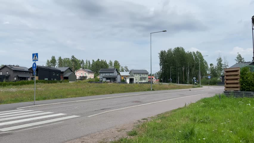 Typical Finnish road. Pedestrian crossing. Cloudy summer day in July. Vantaa, Finland.