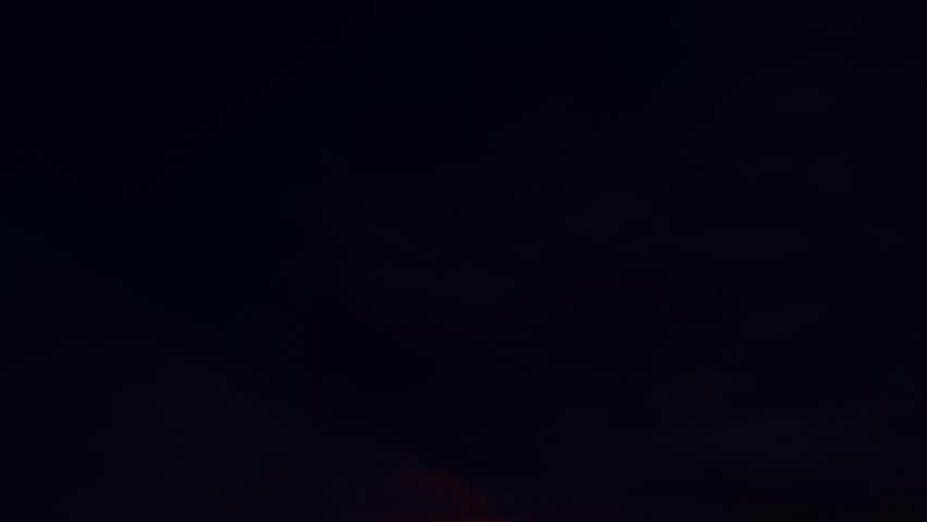 Beautiful sunset sky above clouds with dramatic light. Sunset with sun and clouds on blue and orange dramatic sky with sun rays. Night Sky timelapse. Moving clouds at sunset. Evening Clouds.
