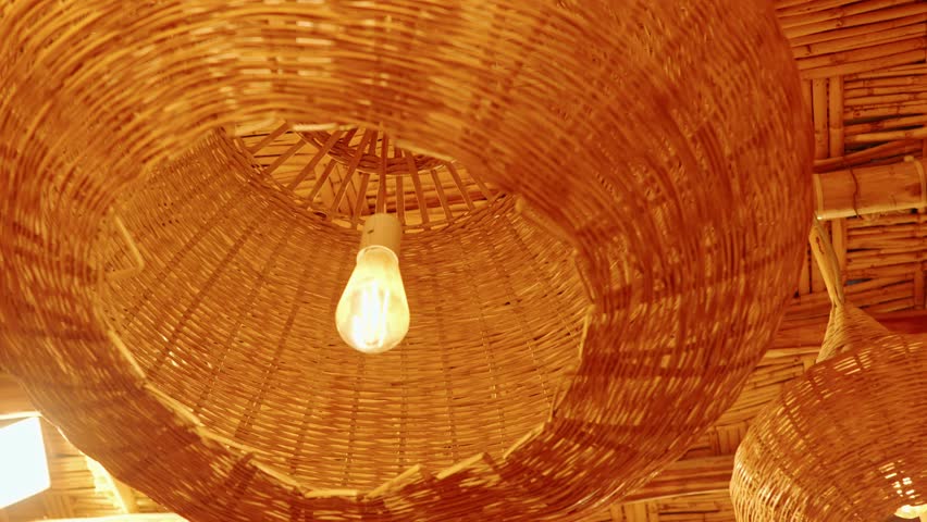 Warm Rattan Pendant Lamps and Woven Bamboo Ceiling in Rustic Tropical Hut Interior