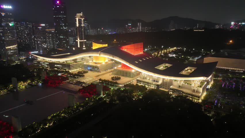 Shenzhen Civic Center and modern architecture at night, illuminated city skyline and contemporary buildings, aerial view, cityscape, drone
