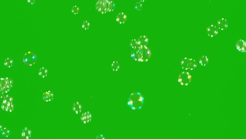 Soap Bubbles Floating in the Green Background. A large number of soap bubbles moving in one direction against a green background. Great for use in blending