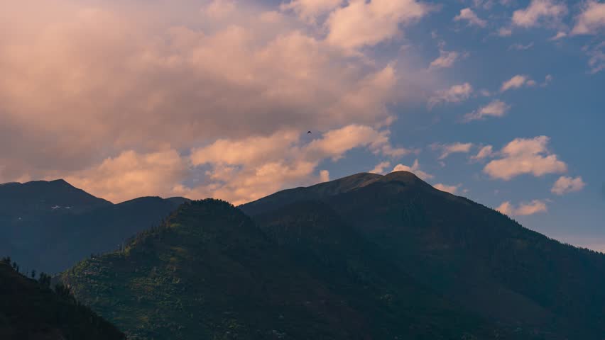 4K Timelapse of orange clouds moving above mountain range during sunset at Manali, Himachal Pradesh, India. Travel India. Nature landscape. Clouds and mountains time lapse.
