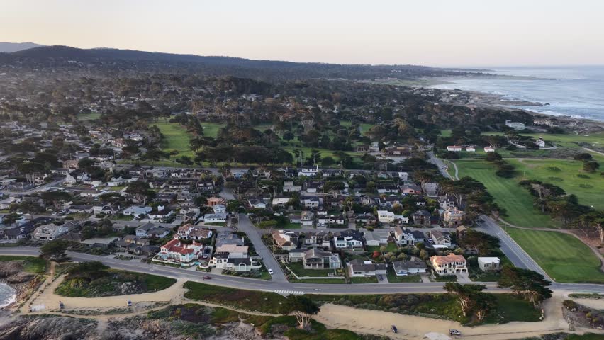 Monterey coastline aerial view with ocean waves, rocky shore, homes and golf course in California, USA. g.
