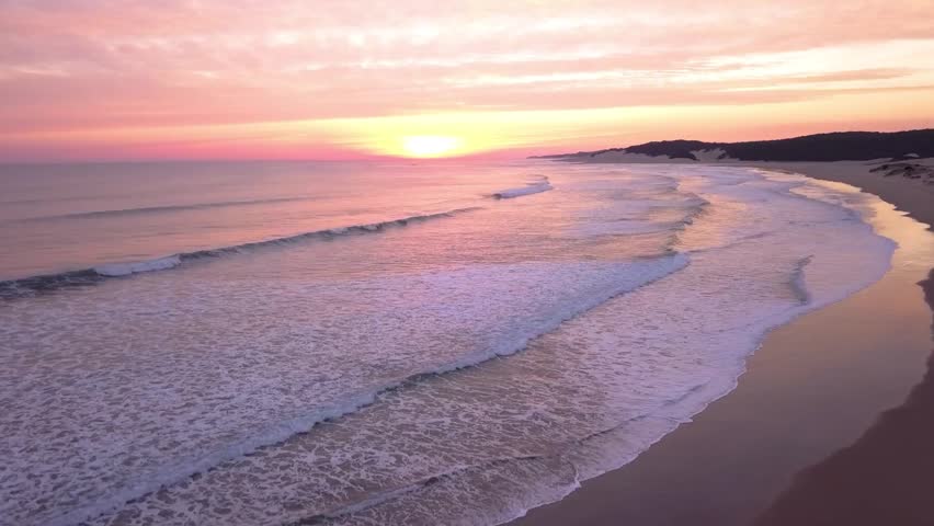 Cinematic sunrise aerial view pristine beach