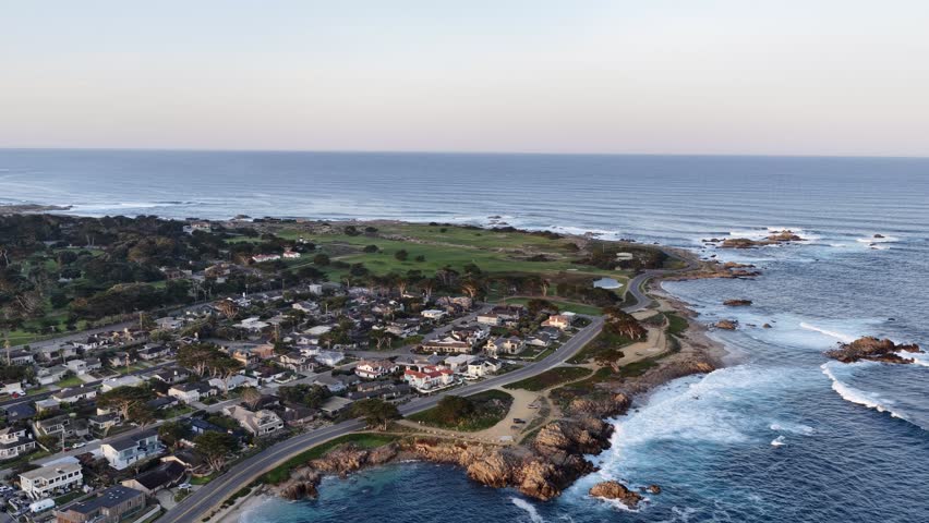 Monterey coastline aerial view with ocean waves, rocky shore, homes and golf course in California, USA. g.