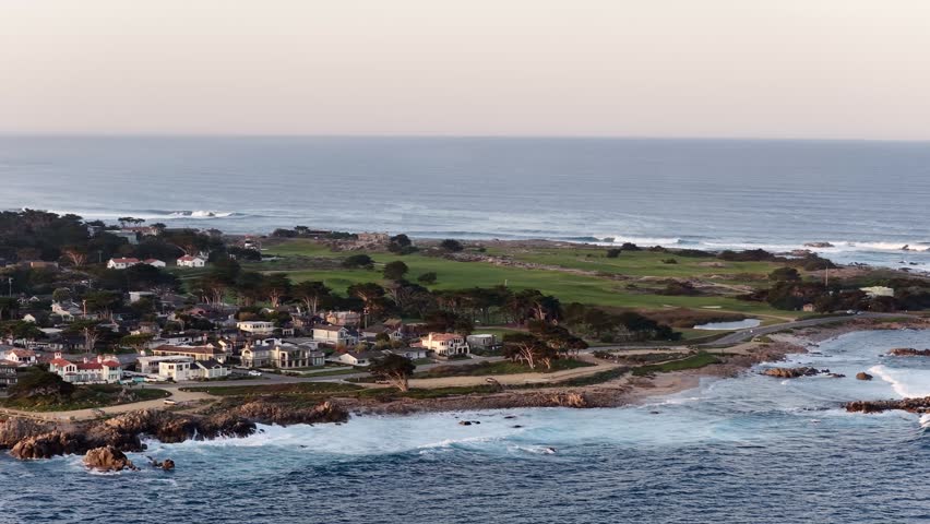 Monterey coastline aerial view with ocean waves, rocky shore, homes and golf course in California, USA. g.