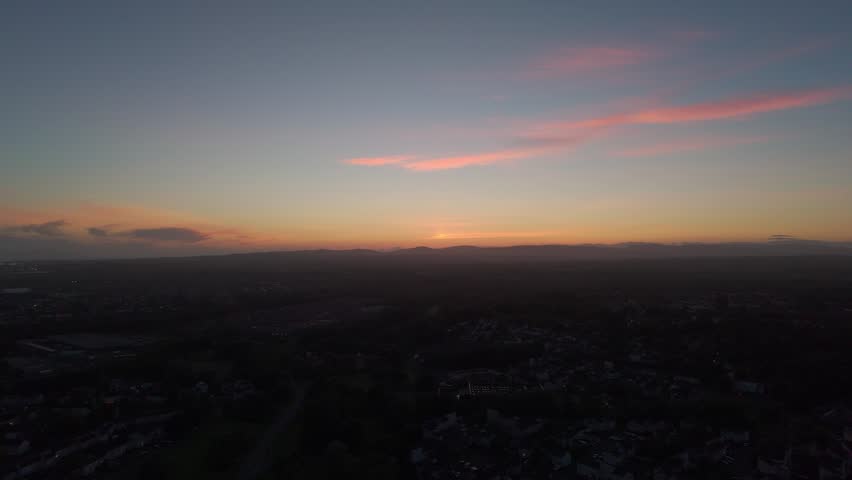 Wide view of a colourful sunset sky above the distant horizon in Florida, USA. Peaceful evening landscape with warm light and soft clouds, ideal for travel, nature and background use
