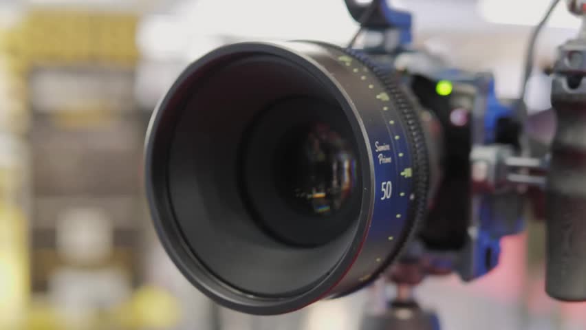 Close-up of a telephoto lens aperture showing vivid glass reflections, ideal for themes of photography, creative vision, focus, and optical technology.
