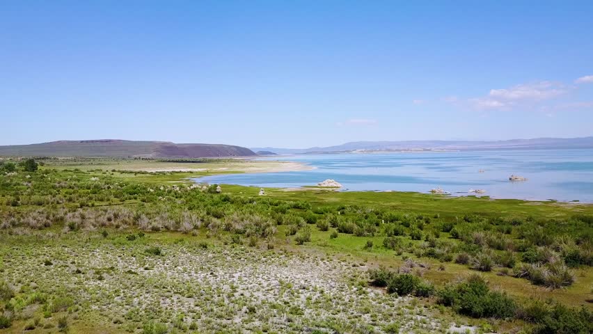 Drone video aerial view lake marshland tufa rock formations.