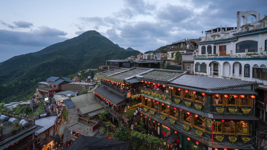 Dusk to night timelapse showing tourists visiting the Old Street shops and teahouses in Jiufen, New Taipei City, Taiwan.