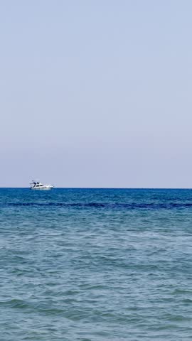 A sailing yacht is sailing on the sea. Ships and yachts sail near the coast and beaches.