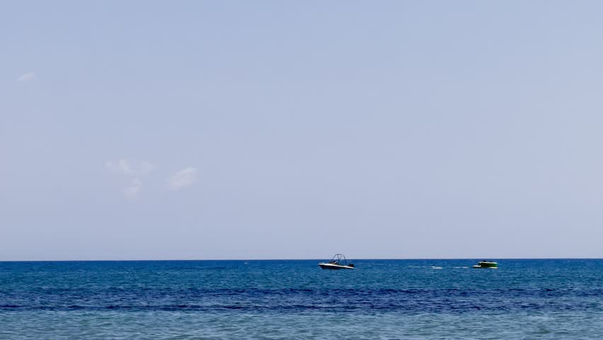 A sailing yacht is sailing on the sea. Ships and yachts sail near the coast and beaches.