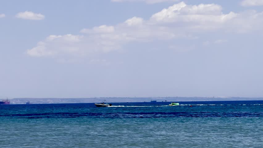 A sailing yacht is sailing on the sea. Ships and yachts sail near the coast and beaches.