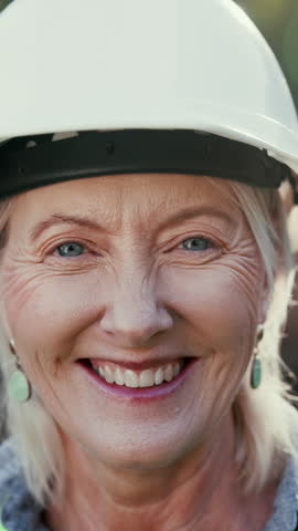 Face, woman and engineer with smile on construction site for inspection or building development. Portrait, mature person and helmet for safety, industrial infrastructure and engineering for expansion
