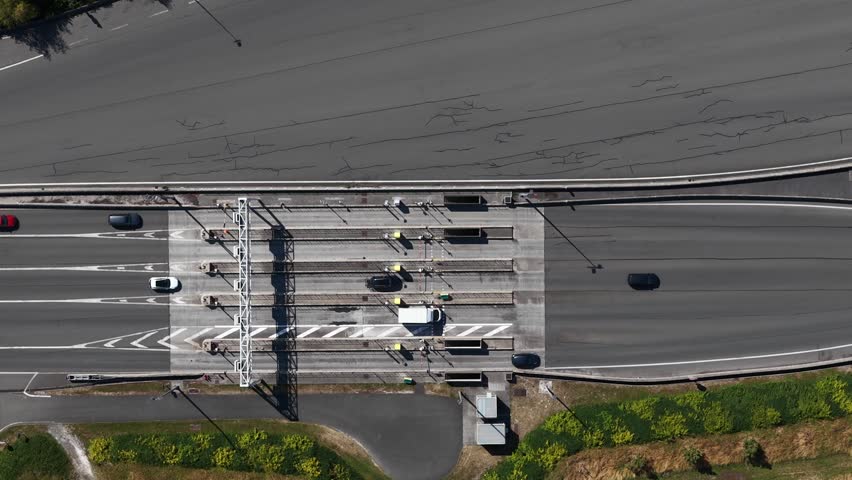 Aerial view of highway toll plaza with cars passing through