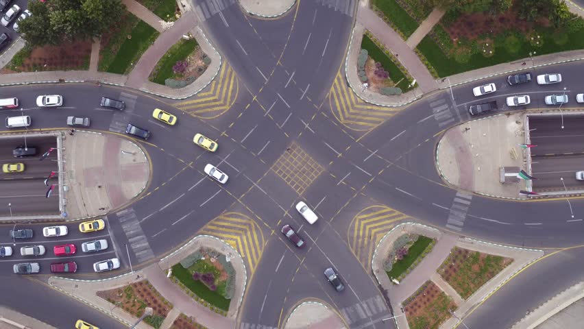 Busy city intersection with cars moving during daytime.
