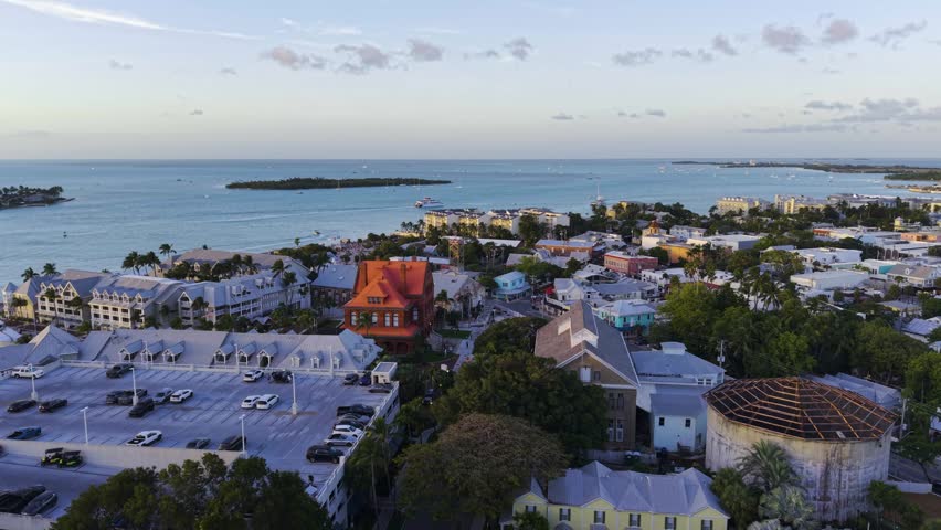 Aerial view of Key West coastal town at sunset with historical architecture and tropical sea horizon.