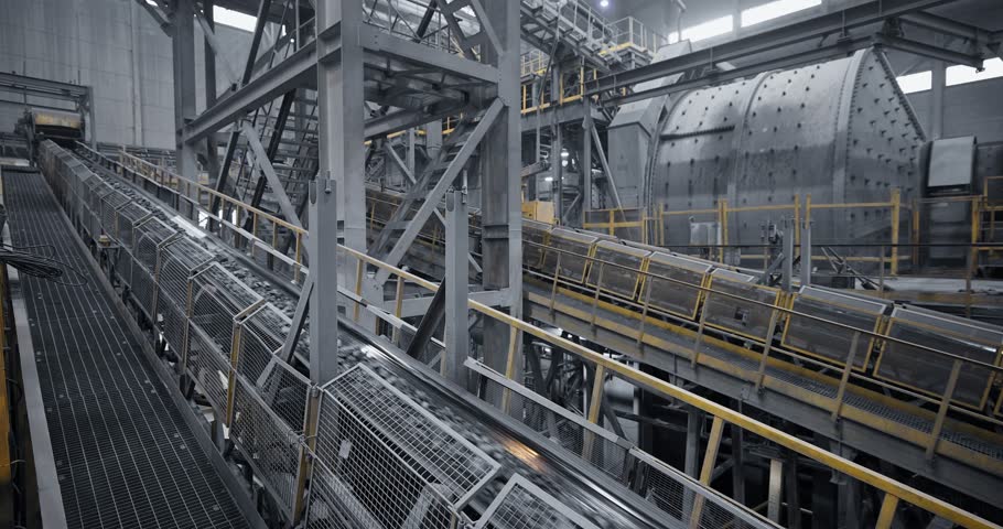 Industry conveyor belt system transporting ore through industrial processing plant, Concentration factory.