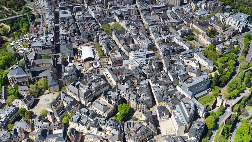 Aerial drone view of the old city of Luxembourg, with the towers of the Notre Dame Cathedral, Place Guillaume II and the Grand Ducal Palace. Panorama of the architecture of the medieval city.