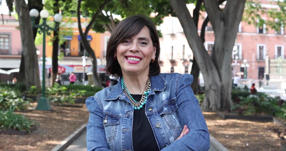 portrait of adult latina woman in public park outdoors in Mexico Latin America, mexican female smiling 