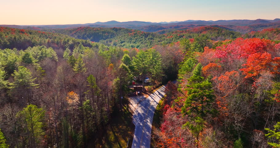Blue Ridge Parkway in autumn. Mountain pass road between dense woods in seasonal colors in North Carolina.