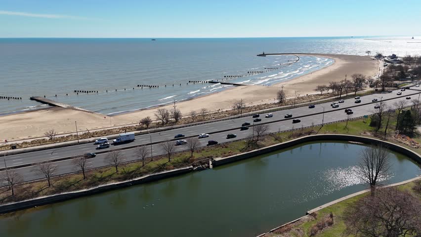 Right to Left traffic and beach waves Chicago Grant Park Aerial Illinois in Spring Time Lake Michigan