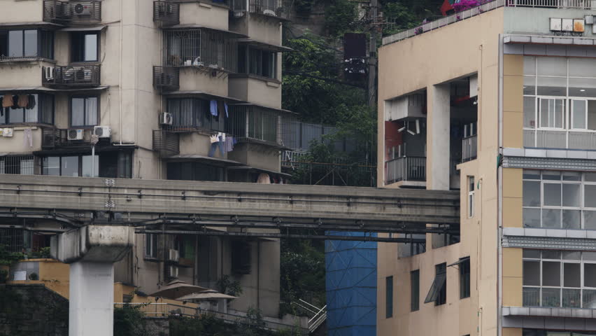 the iconic train enters liziba station inside a building on bridge in Chongqing china