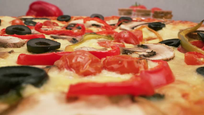 Healthy vegetarian pizza loaded with colorful bell peppers olives and onions.