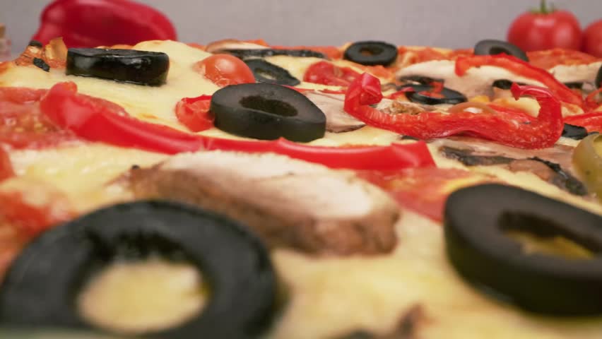 Healthy vegetarian pizza loaded with colorful bell peppers olives and onions.